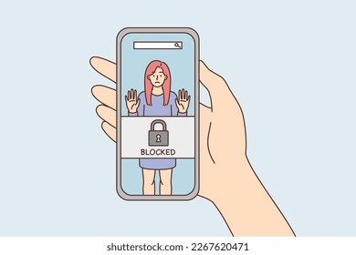 Phone in hand with photo of woman and inscription blocked due to unacceptable behavior. Portrait girl in smartphone screen for concept of blocked and cancelling in social networks