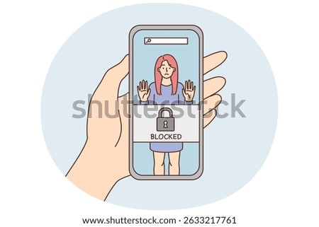 Phone in hand with photo of woman and inscription blocked due to unacceptable behavior. Portrait girl in smartphone screen for concept of blocked and cancelling in social networks