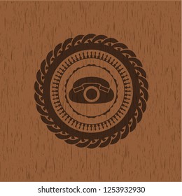 phone icon inside badge with wooden background