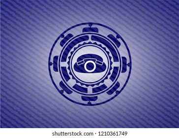 phone icon inside emblem with jean background