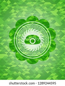 phone icon inside green emblem with triangle mosaic background