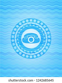 phone icon inside light blue water style badge.