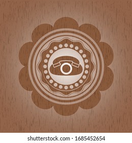 phone icon inside retro style wooden emblem