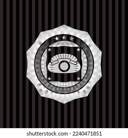 phone icon inside silver shiny badge. 