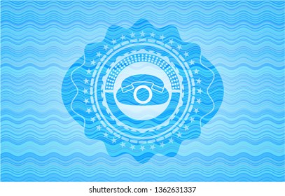 phone icon inside sky blue water style emblem.