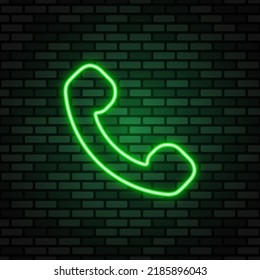 Phone neon icon. Green neon sign on dark brick wall. Best for polygraphy, mobile apps and web design.