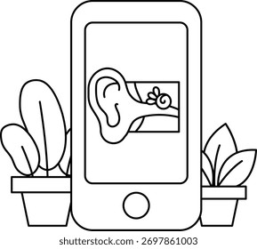 Un teléfono con una imagen de una oreja. El teléfono está en una mesa al lado de una maceta