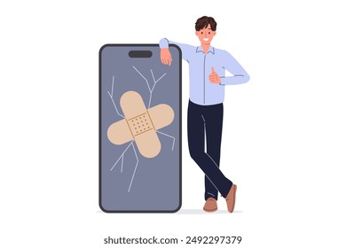 Phone screen repair from man covering cracked display with medical plaster and showing thumbs up. Repairing phone and restoring functionality of gadget yourself after smartphone falls on asphalt