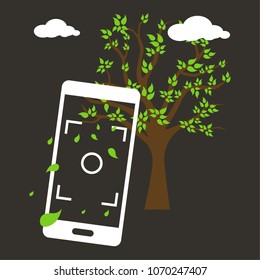 Phone taking picture of a tree scene with falling leaves