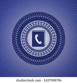 phonebook icon inside emblem with denim texture