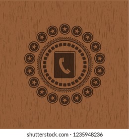 phonebook icon inside retro wooden emblem