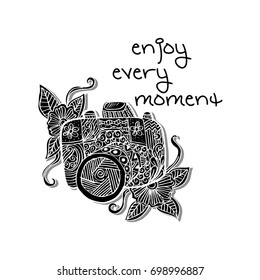 Photo camera with enjoy every moment hand lettering.