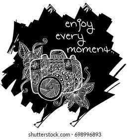 Photo camera with enjoy every moment hand lettering.