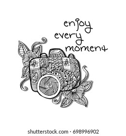 Photo camera with enjoy every moment hand lettering.
