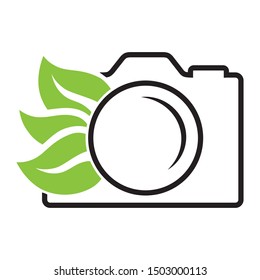 photo camera and green leaves, vector icon