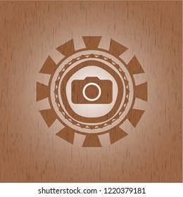 photo camera icon inside badge with wood background