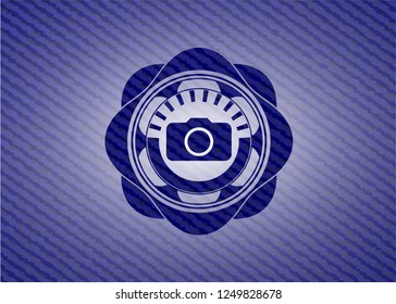 photo camera icon inside badge with jean texture