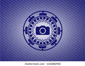 photo camera icon inside badge with denim texture