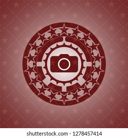 photo camera icon inside badge with red background