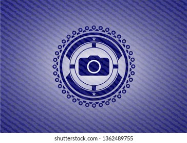 photo camera icon inside badge with denim background