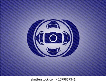photo camera icon inside badge with denim background