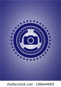 photo camera icon inside badge with jean texture