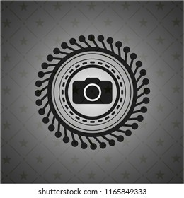 photo camera icon inside black emblem