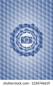 photo camera icon inside blue emblem with geometric background.