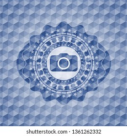 photo camera icon inside blue badge with geometric background.