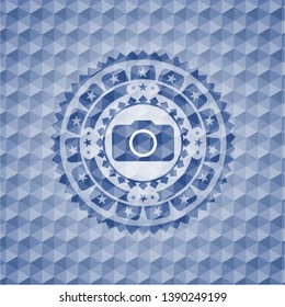 photo camera icon inside blue emblem with geometric pattern background.