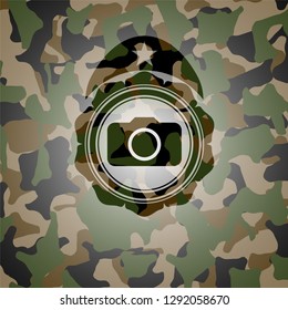 photo camera icon inside camouflaged emblem