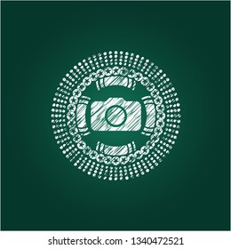photo camera icon inside chalkboard emblem on black board