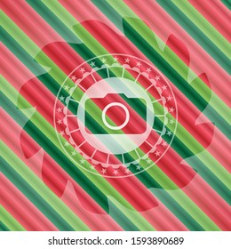 photo camera icon inside christmas badge background.