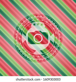 photo camera icon inside christmas style emblem.