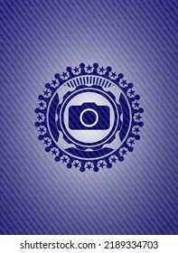 photo camera icon inside denim background. 