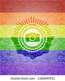 photo camera icon inside emblem on mosaic background with the colors of the LGBT flag