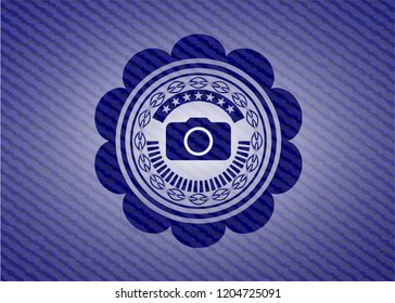 photo camera icon inside emblem with denim texture