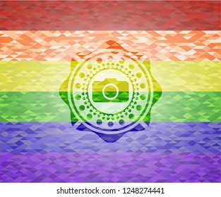 photo camera icon inside emblem on mosaic background with the colors of the LGBT flag