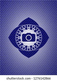 photo camera icon inside emblem with jean background