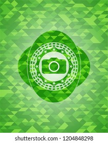 photo camera icon inside green mosaic emblem