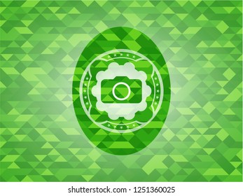 photo camera icon inside green emblem with triangle mosaic background