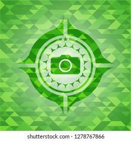 photo camera icon inside green mosaic emblem