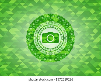 photo camera icon inside green mosaic emblem