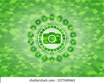 photo camera icon inside green emblem with mosaic background