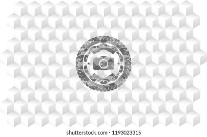 photo camera icon inside grey emblem with cube white background