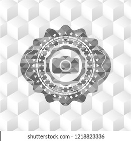photo camera icon inside grey badge with geometric cube white background