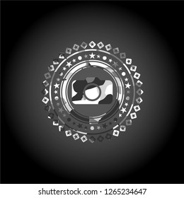 photo camera icon inside grey camouflaged emblem