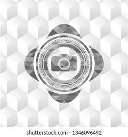 photo camera icon inside grey emblem with cube white background