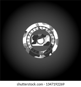 photo camera icon inside grey camouflaged emblem