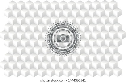 photo camera icon inside grey emblem with cube white background
